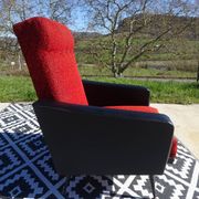 Pair of vintage armchairs in black faux leather and red fabric.