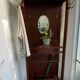 Antique wooden coat rack with mirror and shelf.