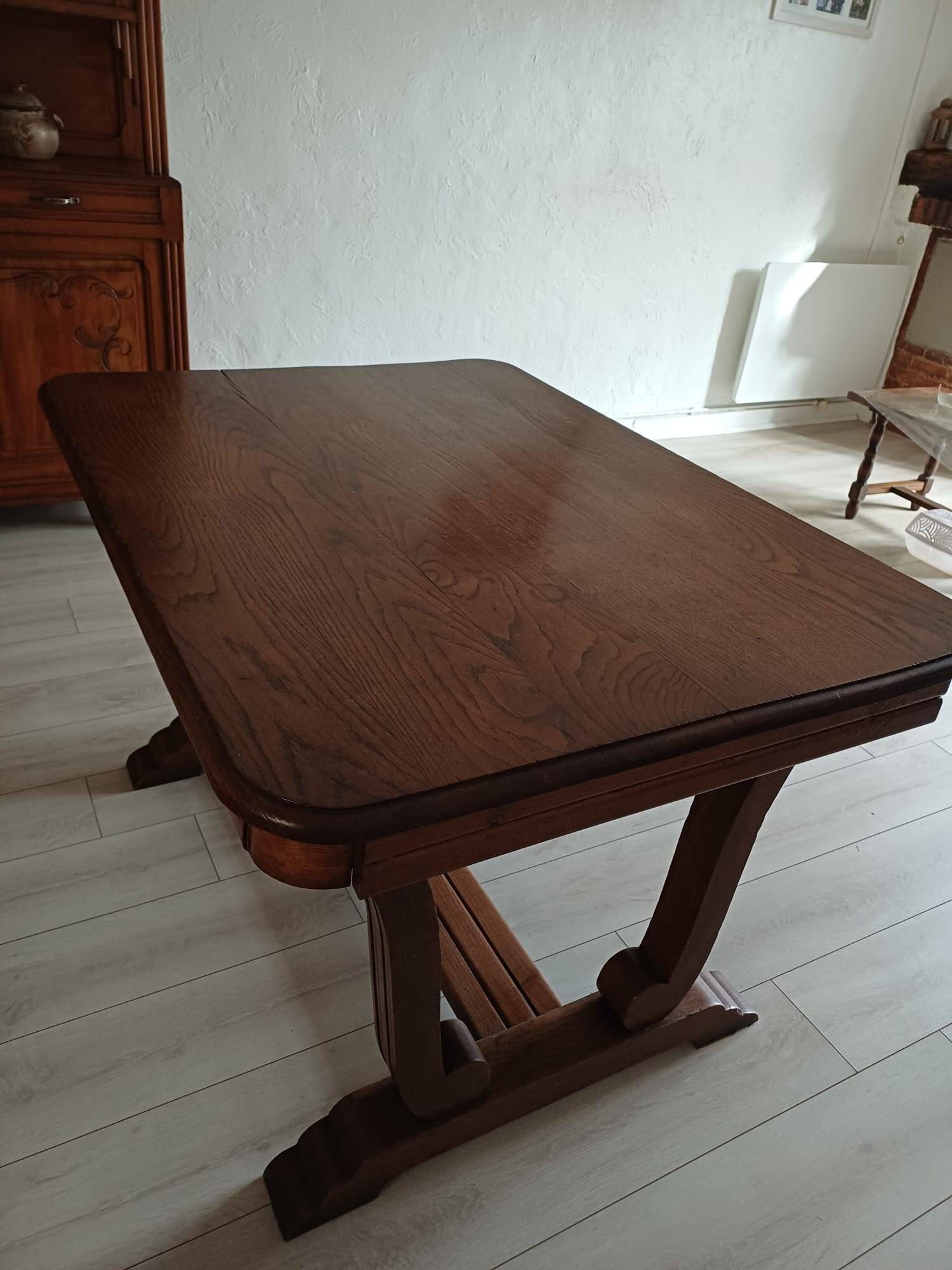 Solid wood dining table with a sculptural base.