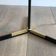 Designer floor lamp in black lacquered metal and brass