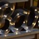 Ancient Light Sign in aluminium lettering forming the word "BAR"