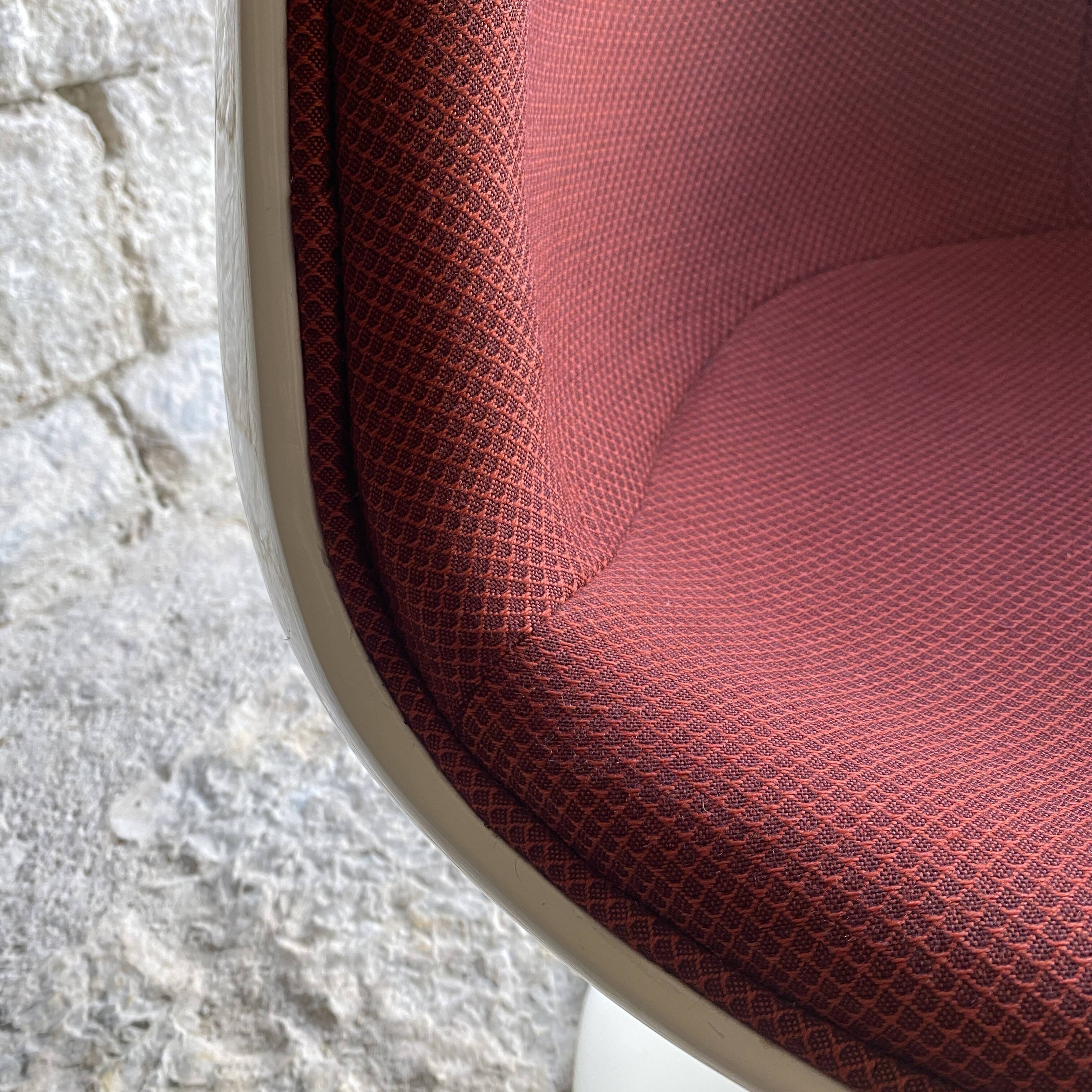 Two cognac-colored swivel chairs made of fiberglass from the 1970s