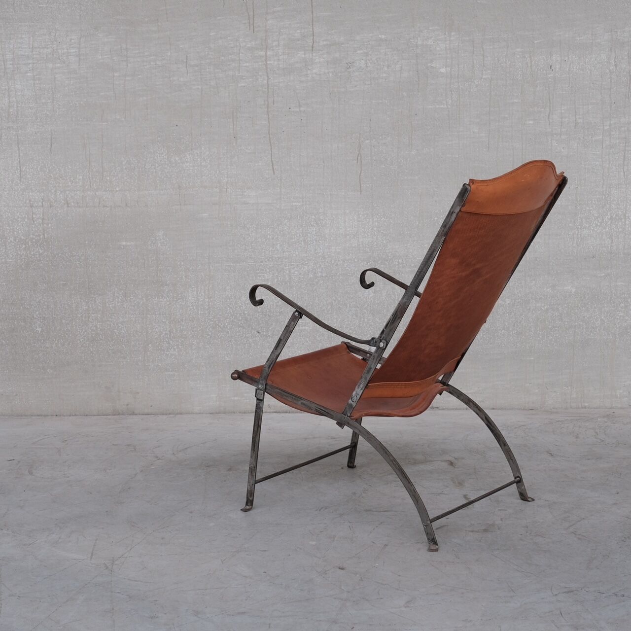 Pair of mid-century leather and metal folding armchairs