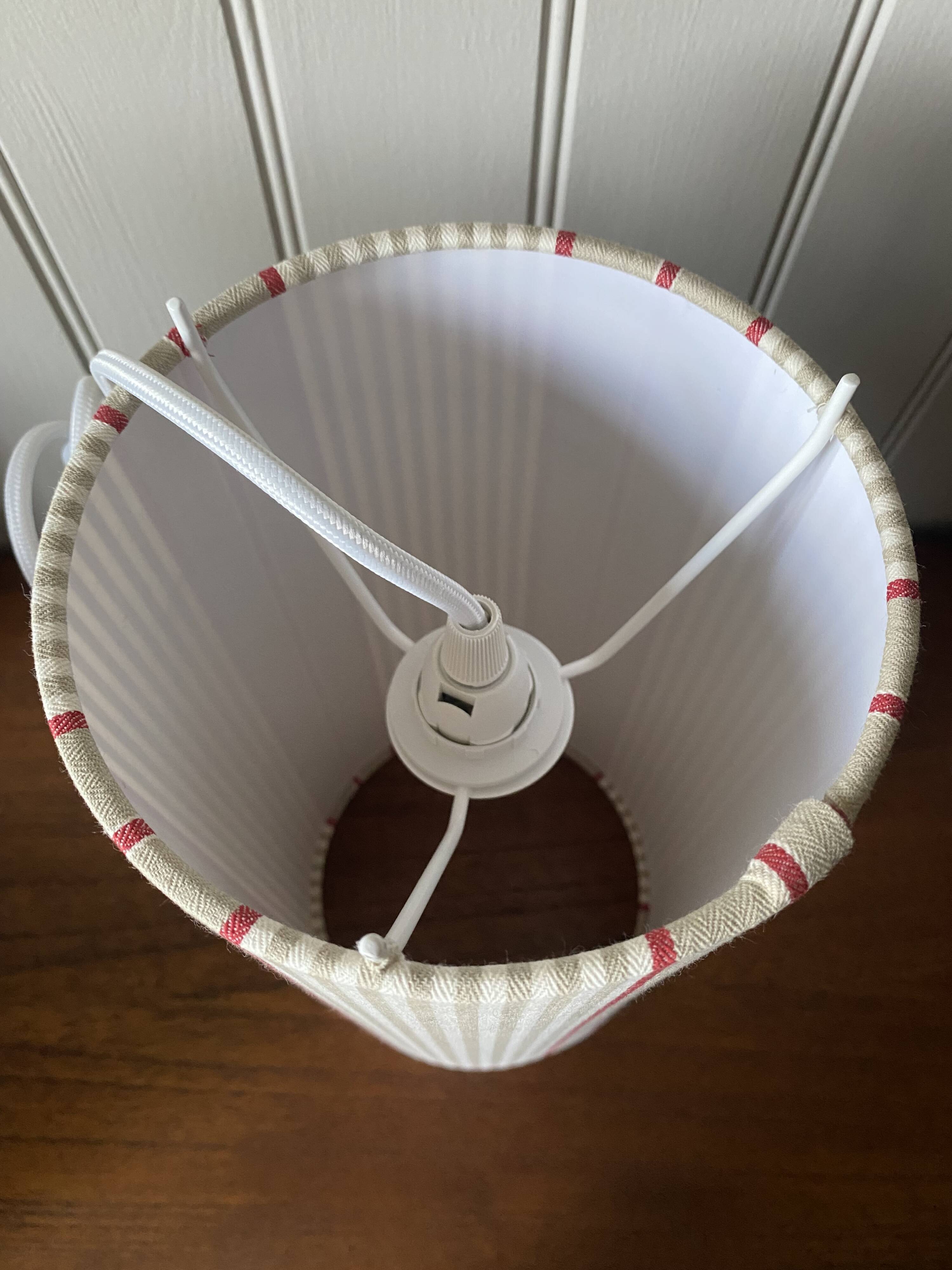 Pair of striped fabric bedside lamps.