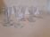 Set of 9 small cut glass stemmed glasses from the 1930s, in various sizes.