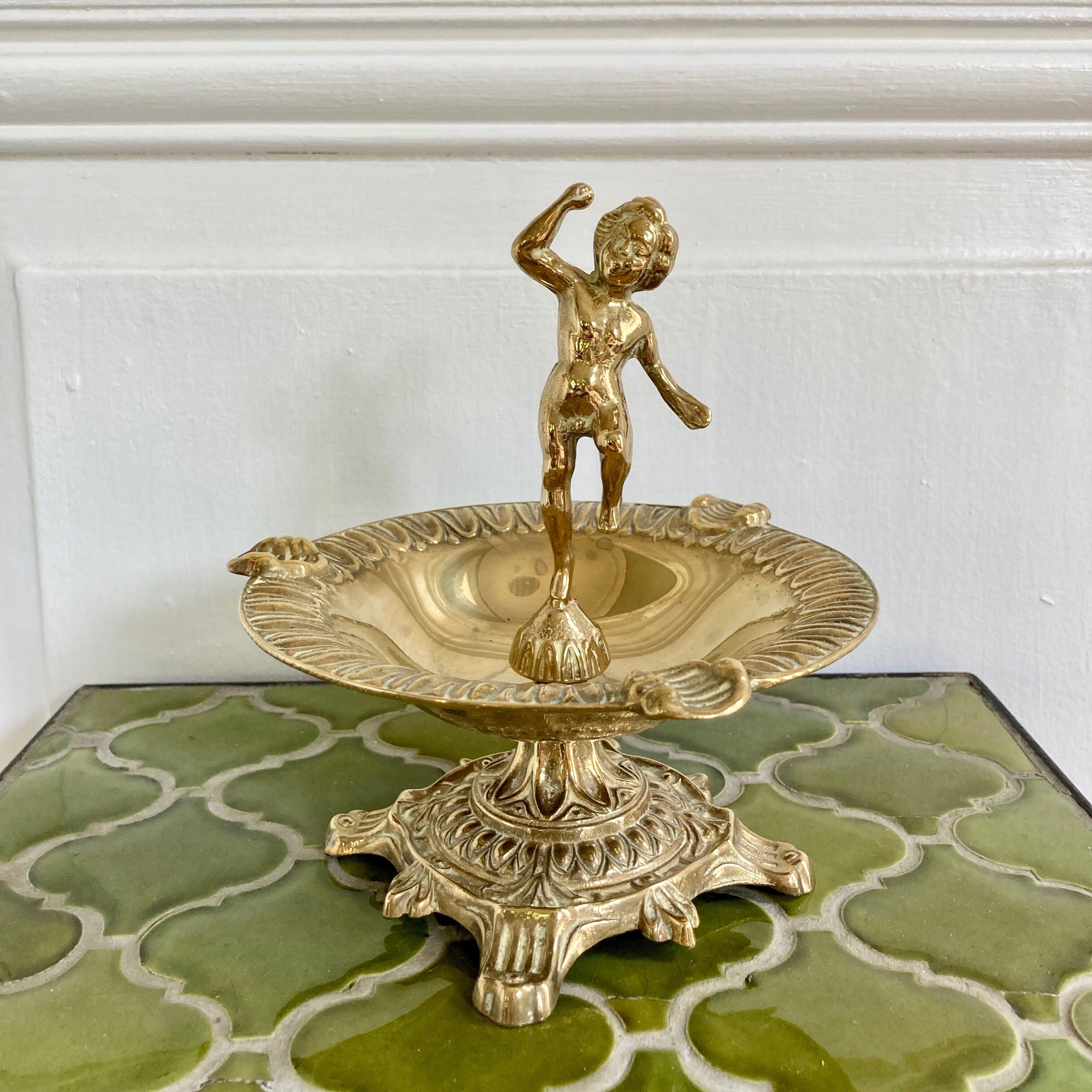 Brass cherub pocket-empty ashtray