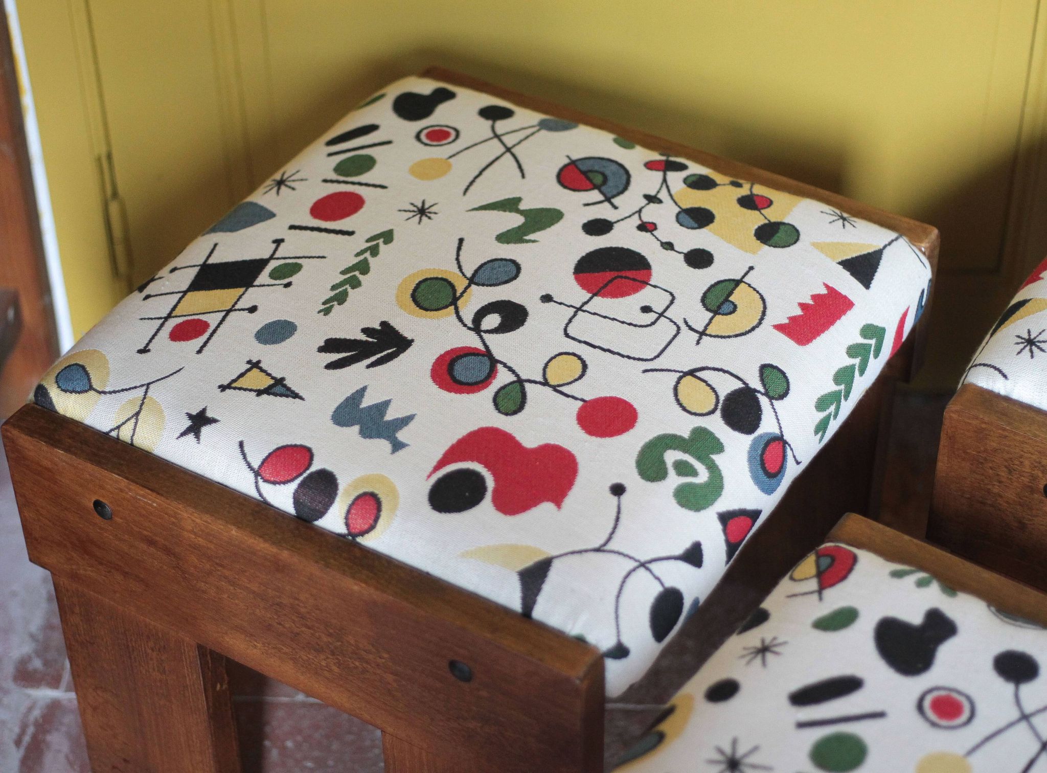 Set of 3 beech wood stools with fabric upholstery in the style of Miro.