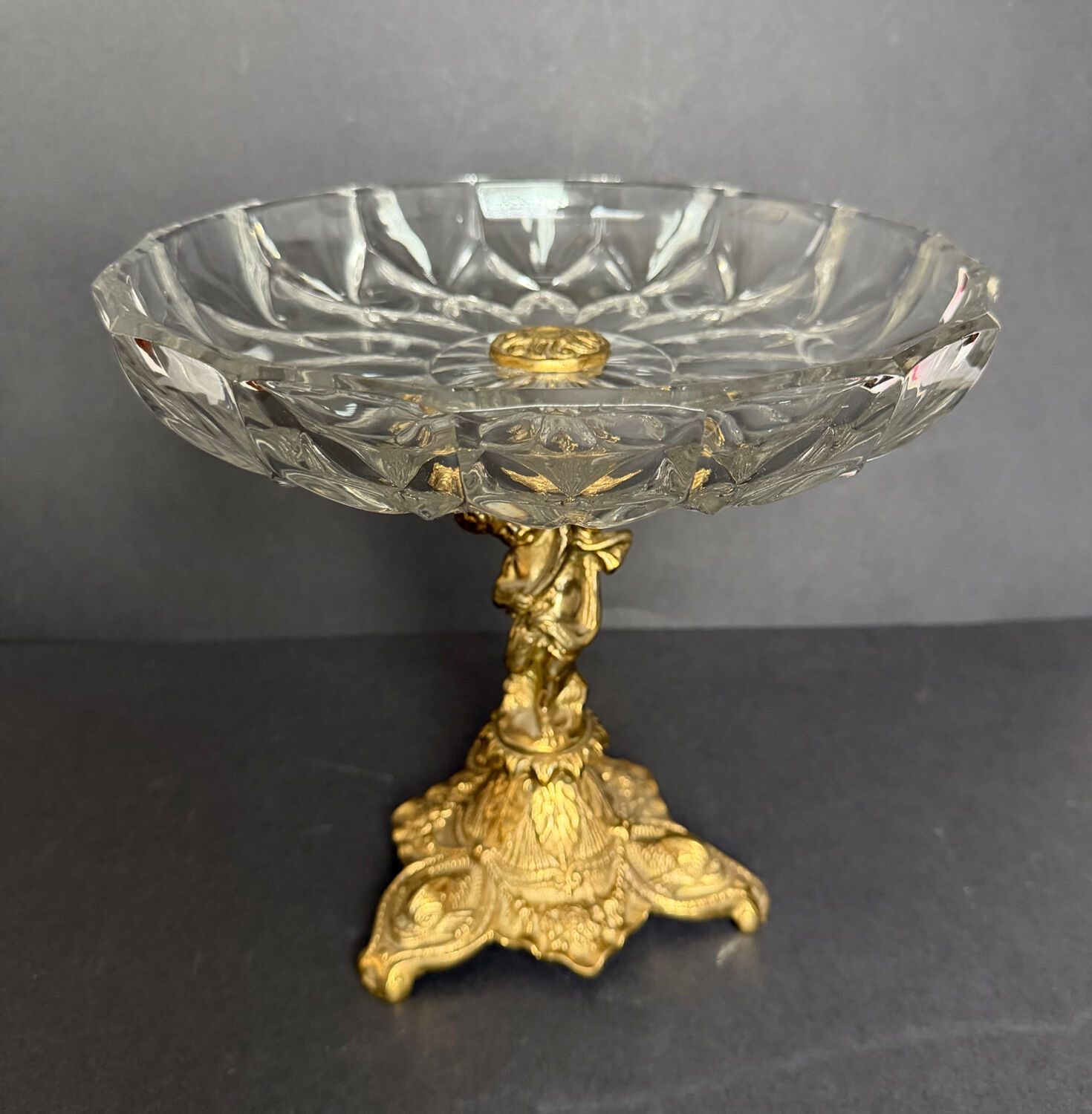 Antique crystal bowl on a bronze stand.