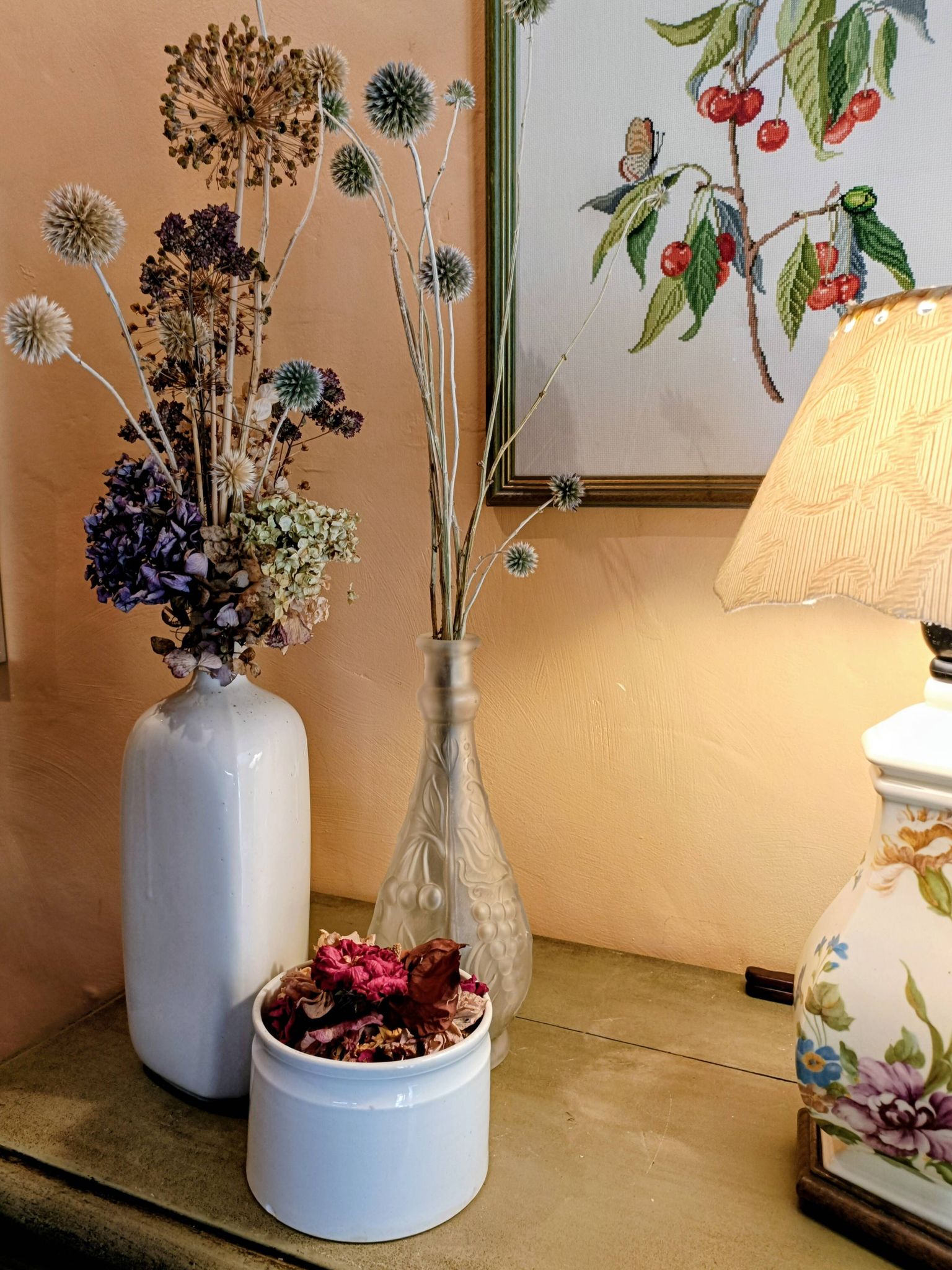 Frosted transparent glass carafe with raised cherry and grape patterns.