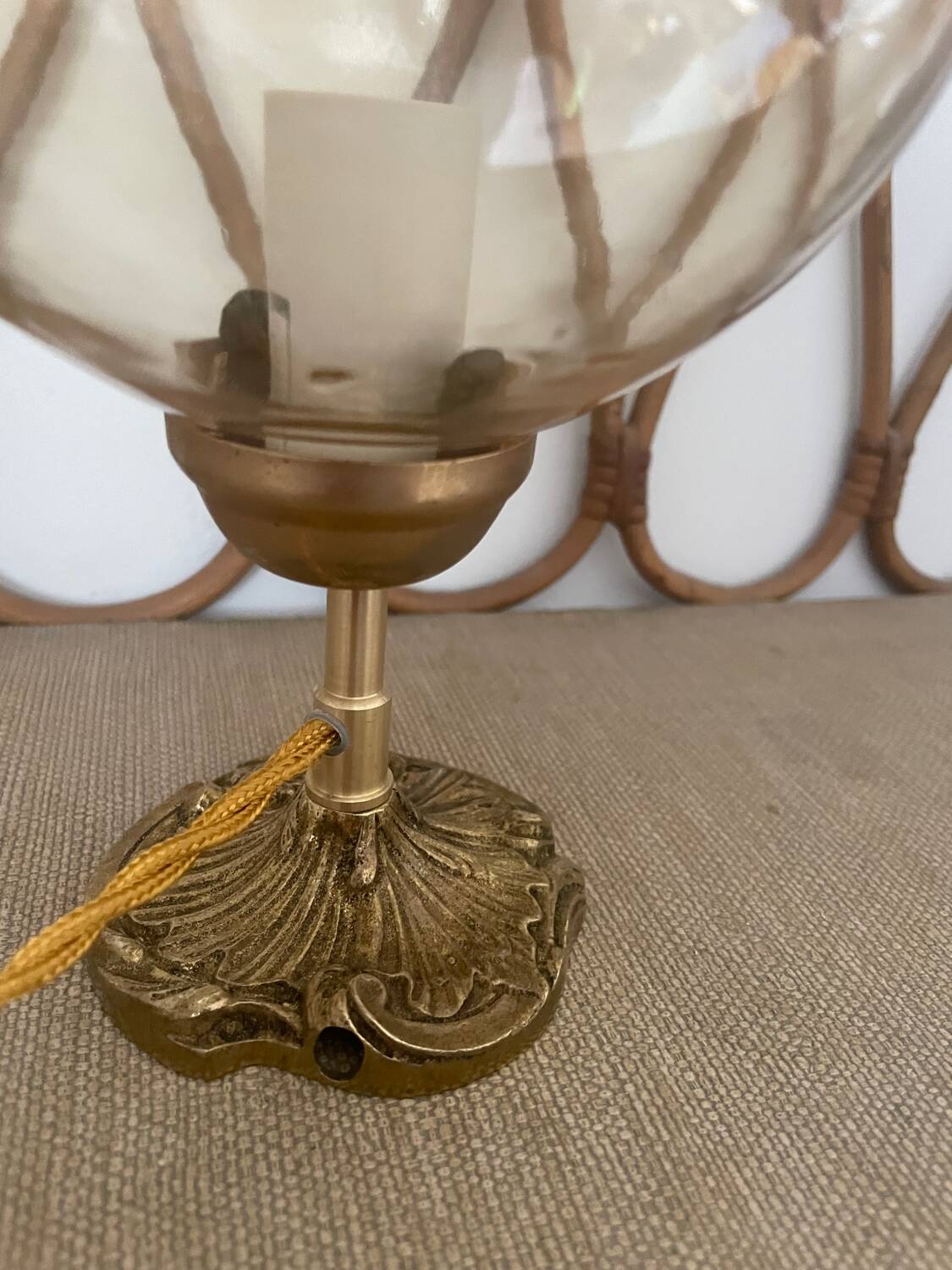 2 bedside lamps with round amber glass globes and gold metal.