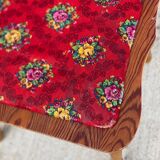 2 curved wood and red fabric chairs