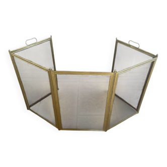 Five-panel golden metal fireplace screen from the 19th century.