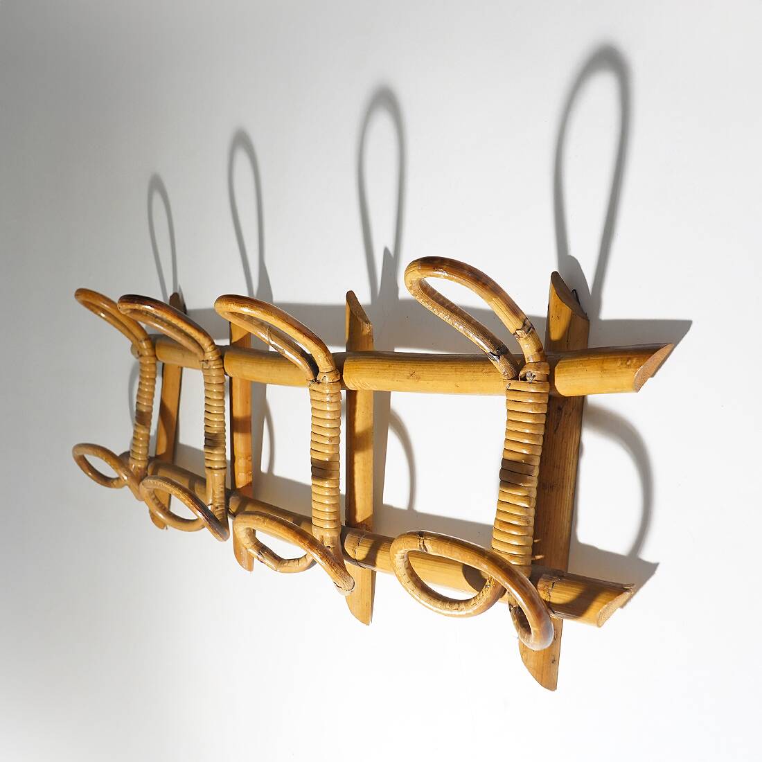 Wall coat rack in rattan and woven wicker, 1960s.