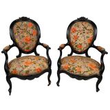 Pair of Napoleon III armchairs, in blackened wood, floral patterned fabric