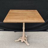 Bistro table with cast iron base and solid teak top