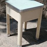 Shoe polish stool with round top and aluminum legs.