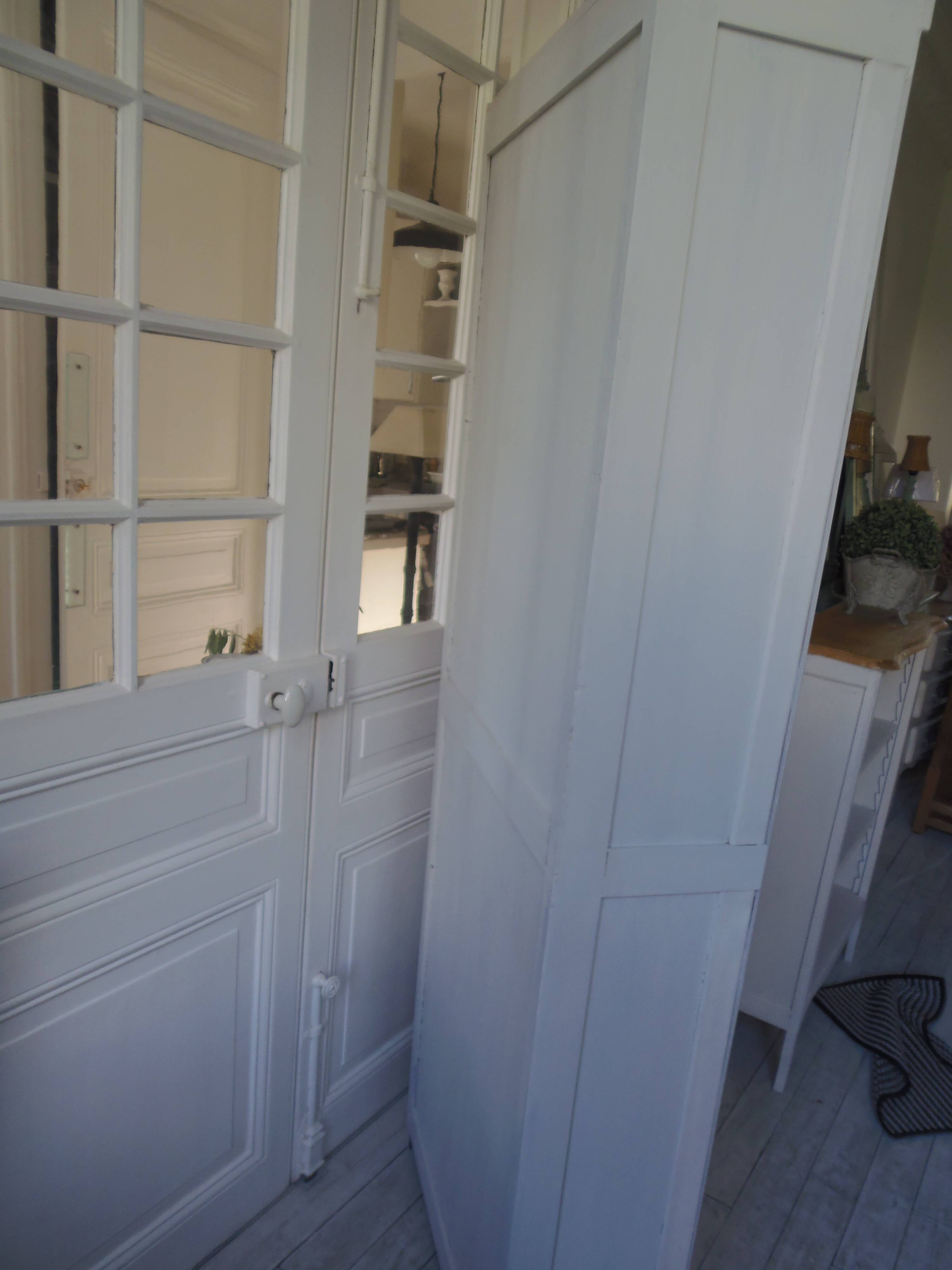 Shallow depth bookcase re-enchanted in pearl gray, wooden shelves.