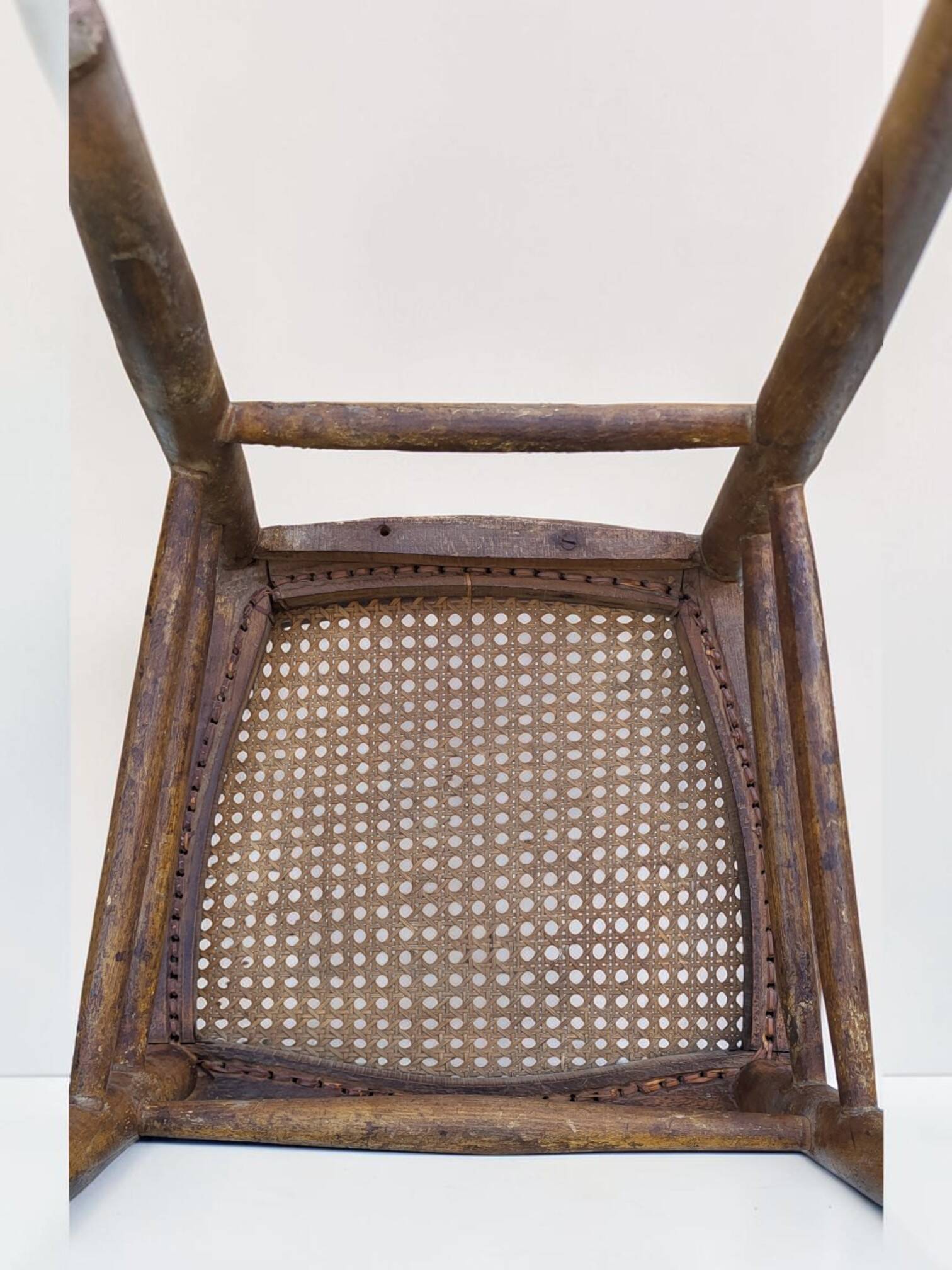 Chair with a slatted backrest and caned seat.