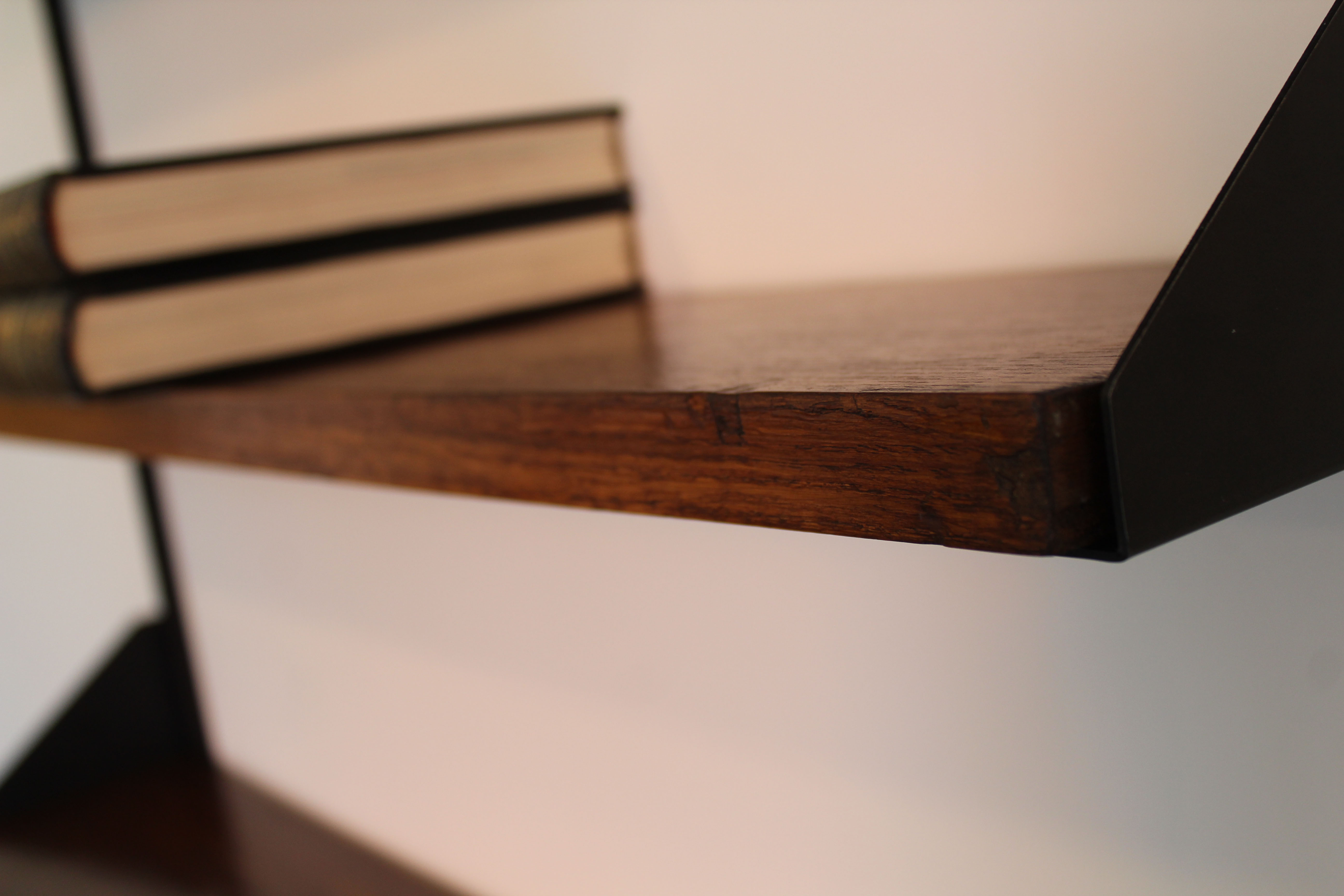 Shelves in rosewood and black lacquered metal from the 50s