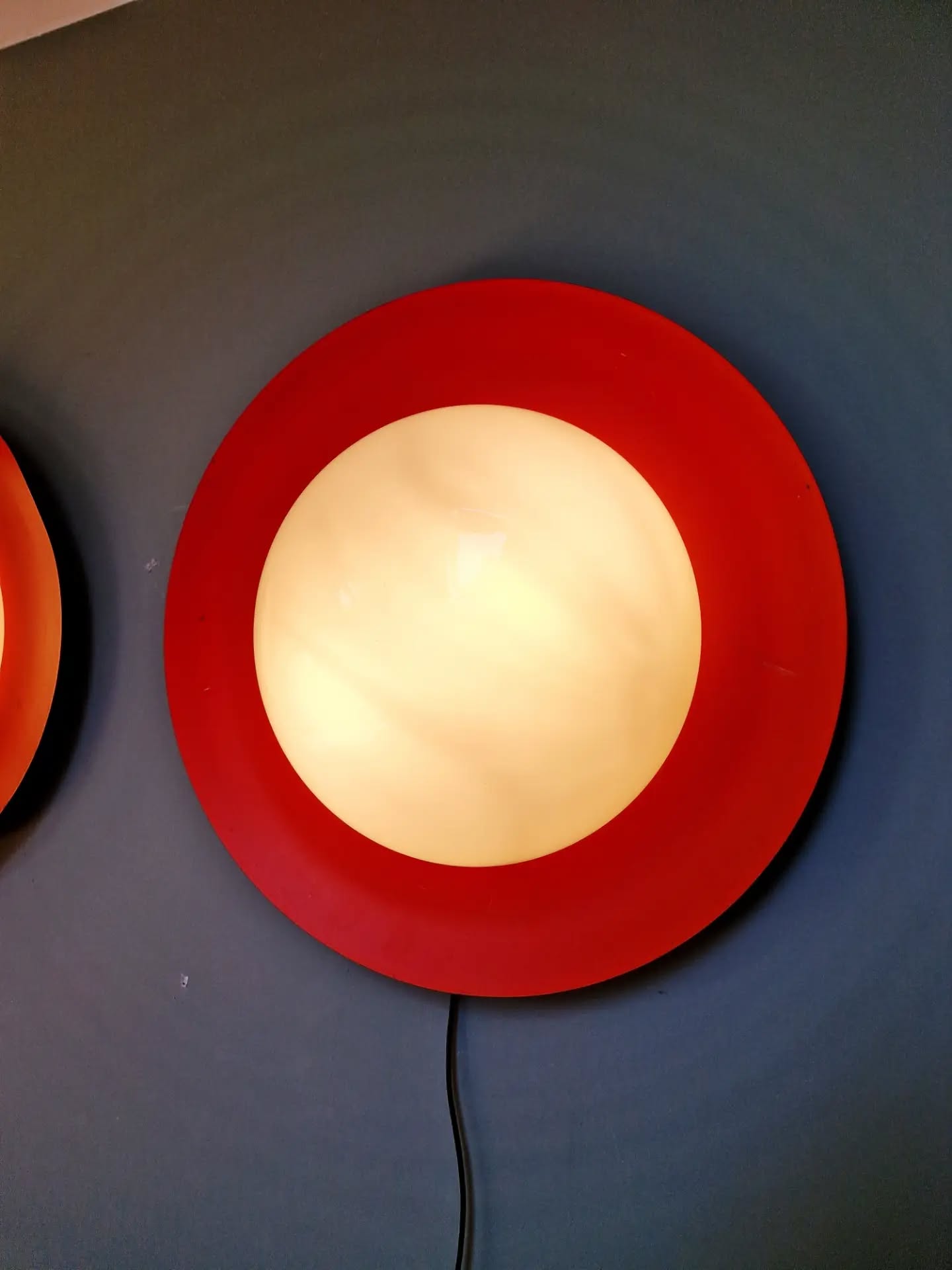 Pair of XXL Space Age wall sconces, orange lacquered metal and opaline, 1960.