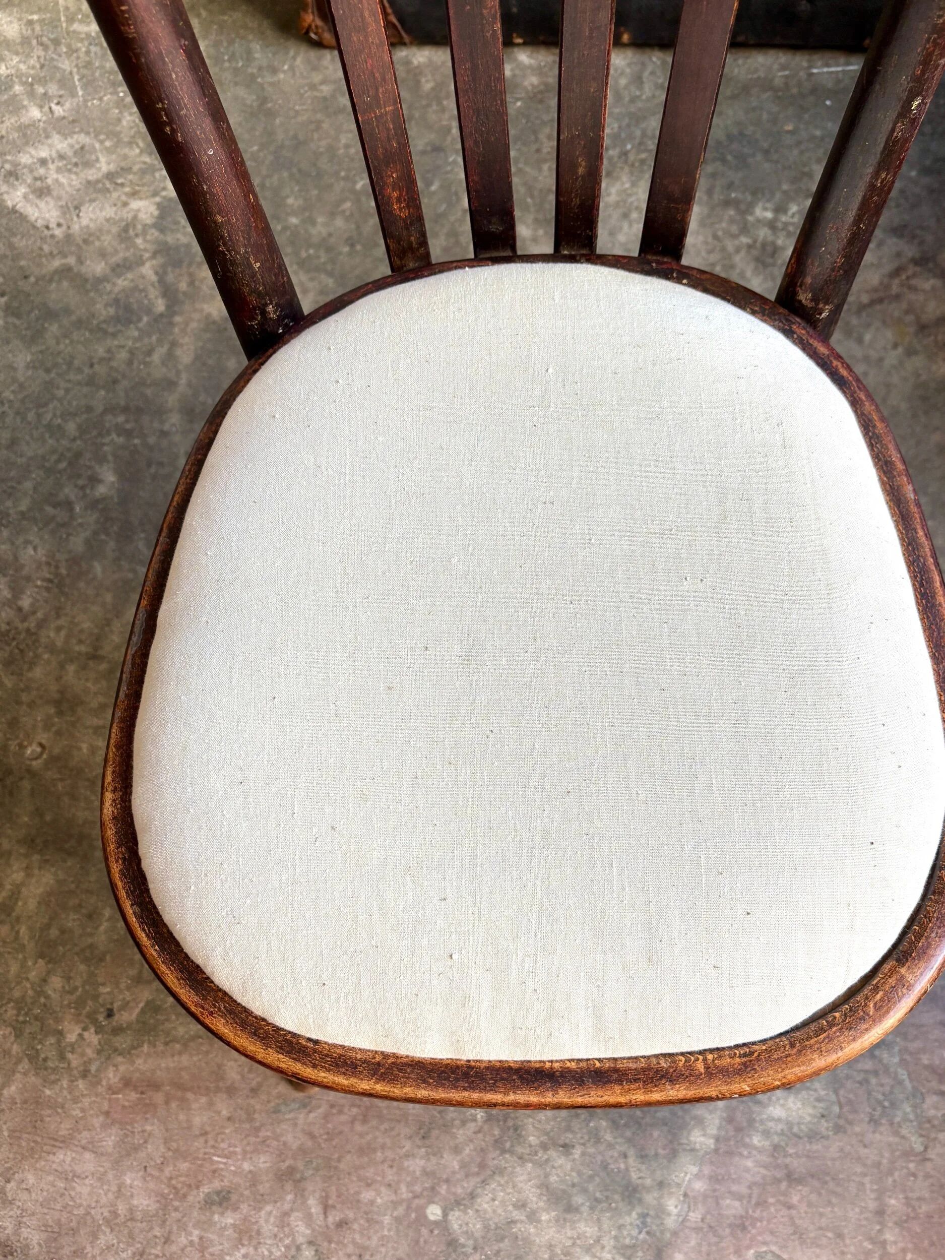 Bistro chair in bent beech and beige mixed fabric.