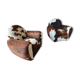 Pair of club chairs covered in cowhide