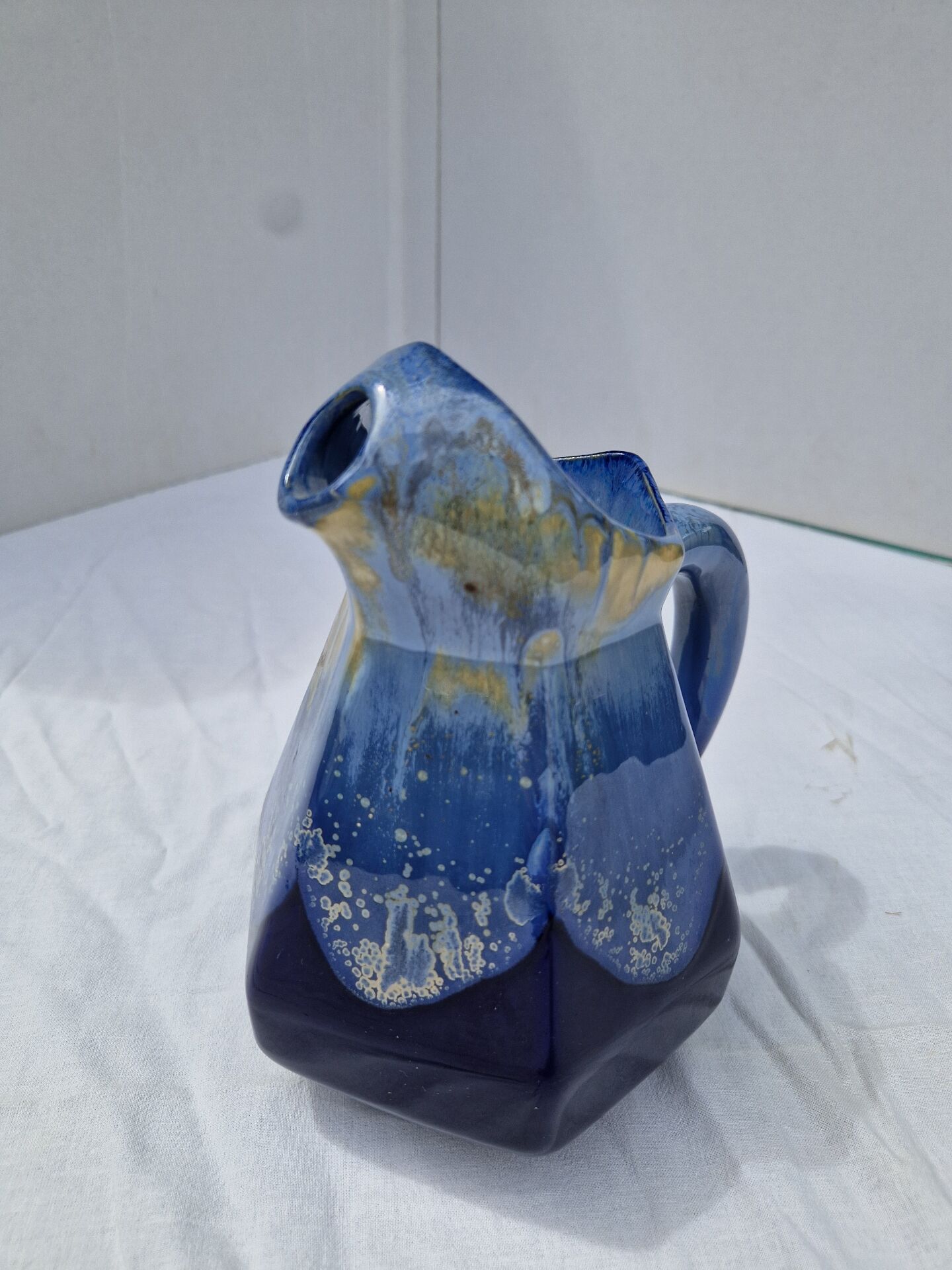 Old flamed ceramic jug. Very beautiful shades of blue, 6 sides.