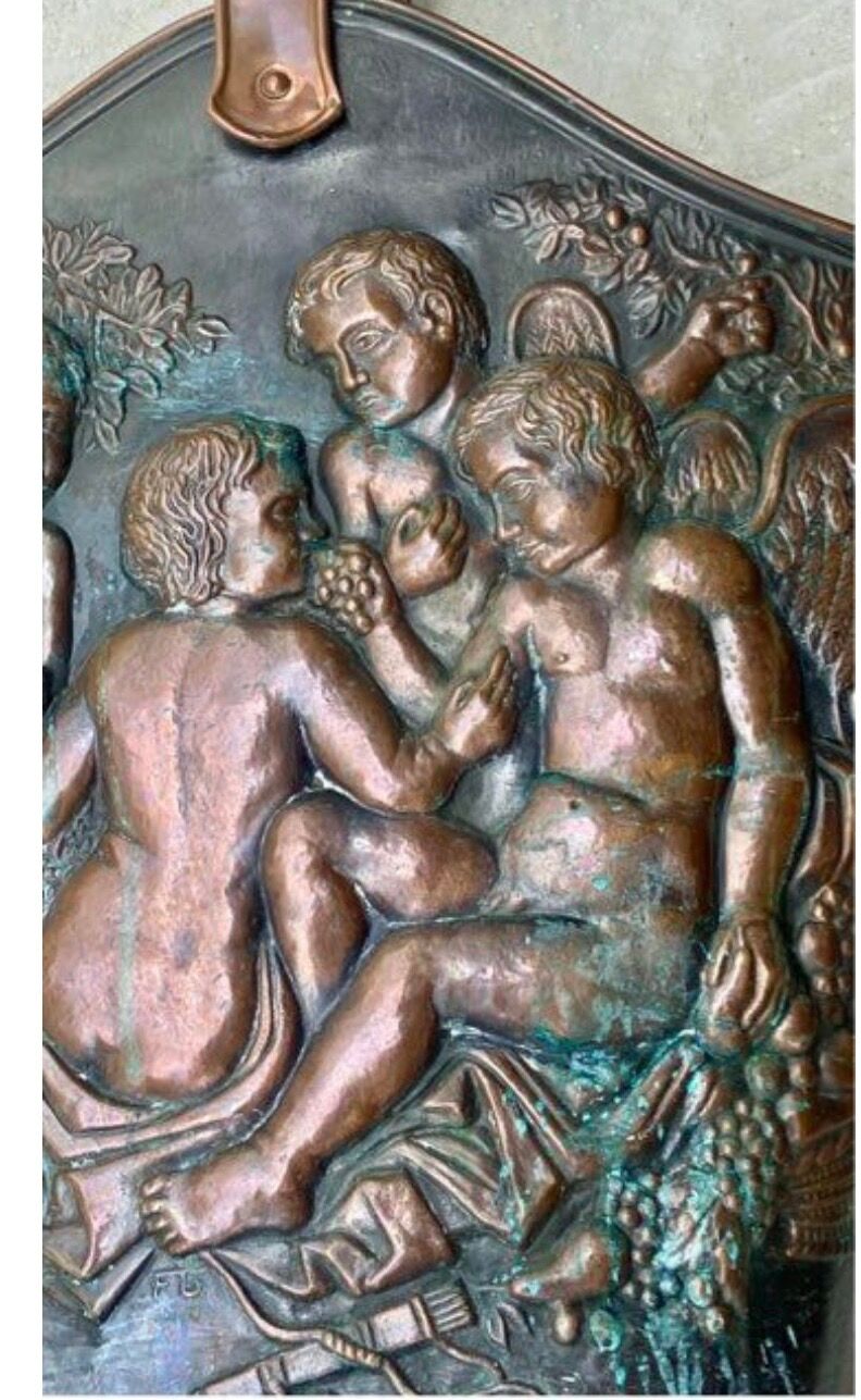 Antique red copper umbrella stand decorated with putti angels.