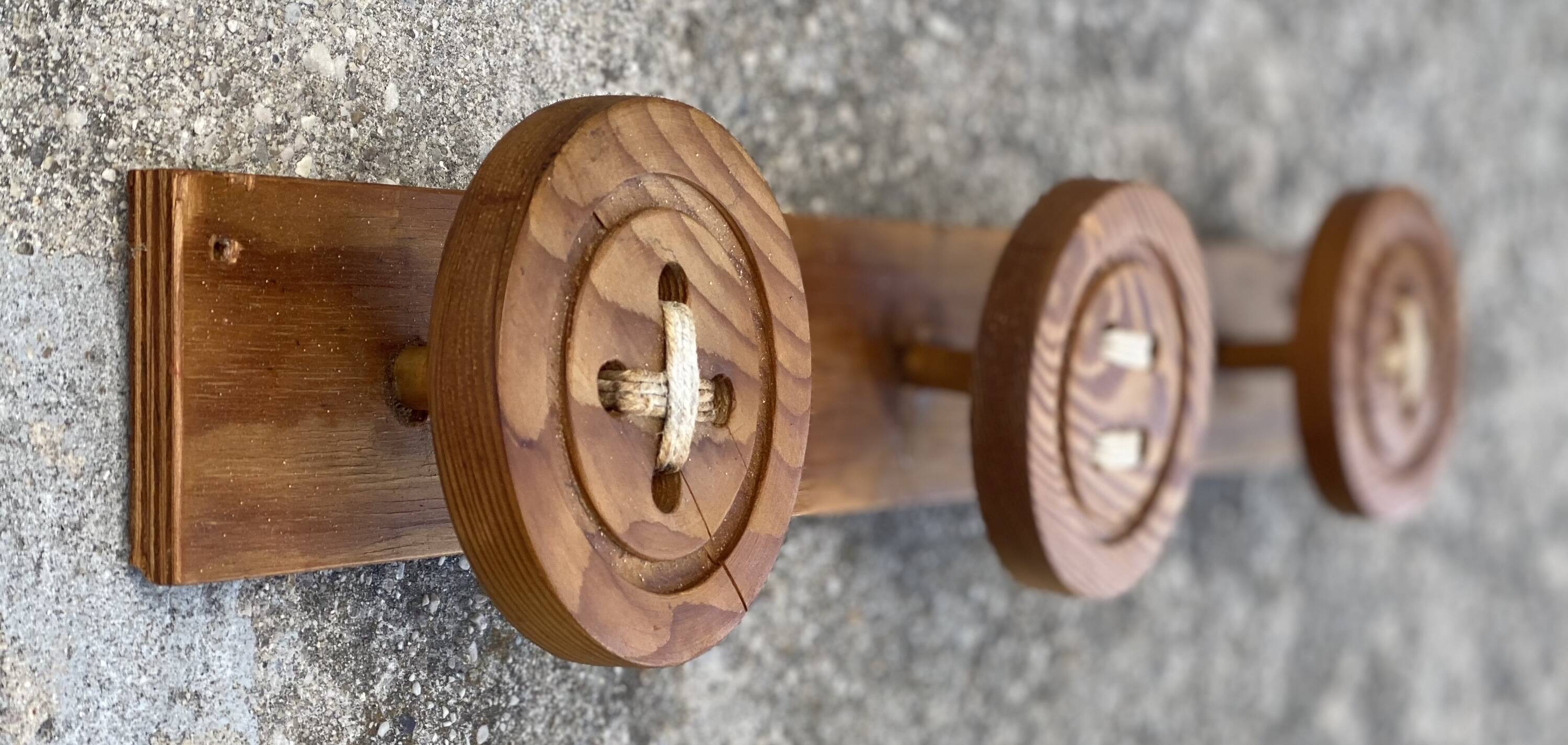 Vintage 1980 coat rack with 3 "button" hooks.