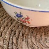 Flowery bowl with blue edging.