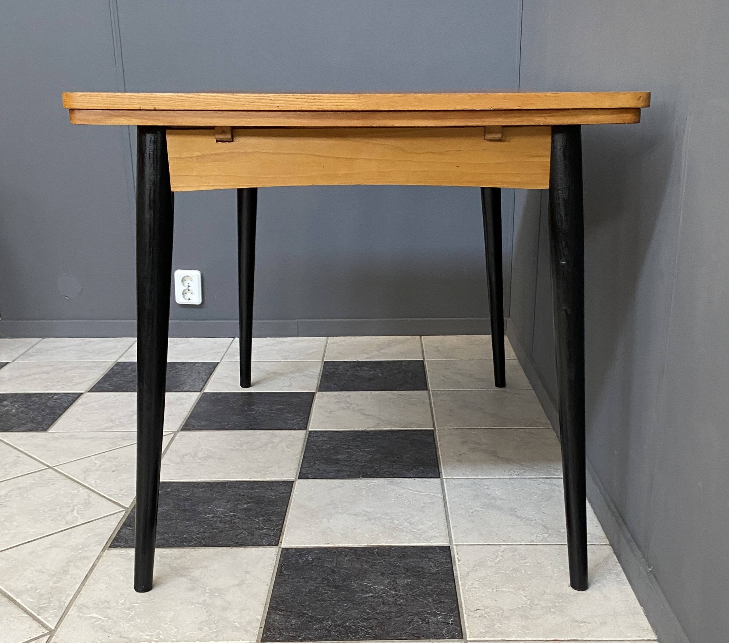 Wood enlarging dining table black wood legs 1960s