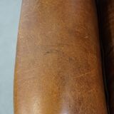 Cognac-colored sheepskin wing chair in English style