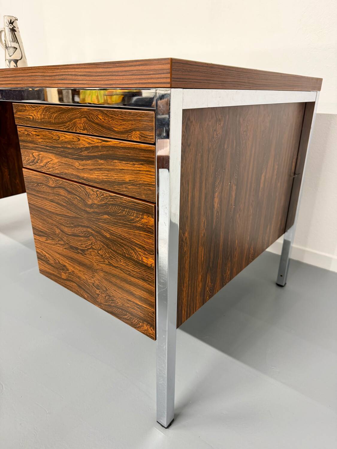 Vintage desk with rosewood veneer and chrome metal design from the 1970s.