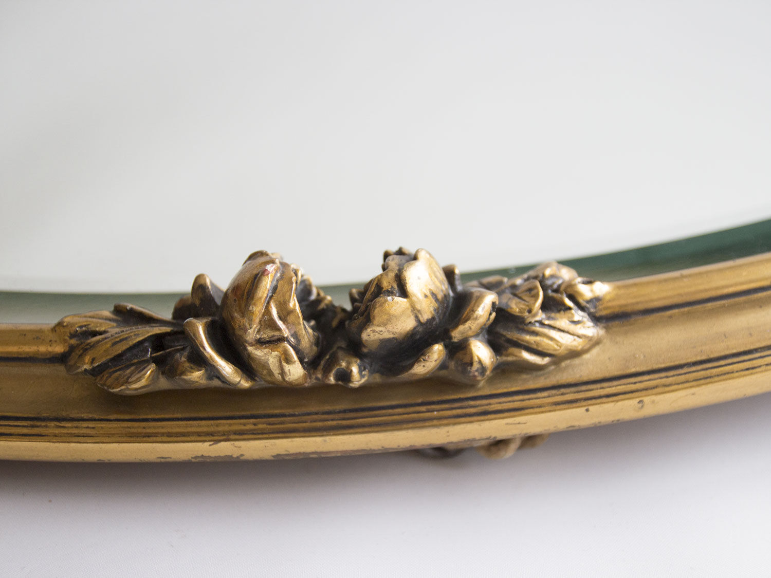 Golden oval mirror