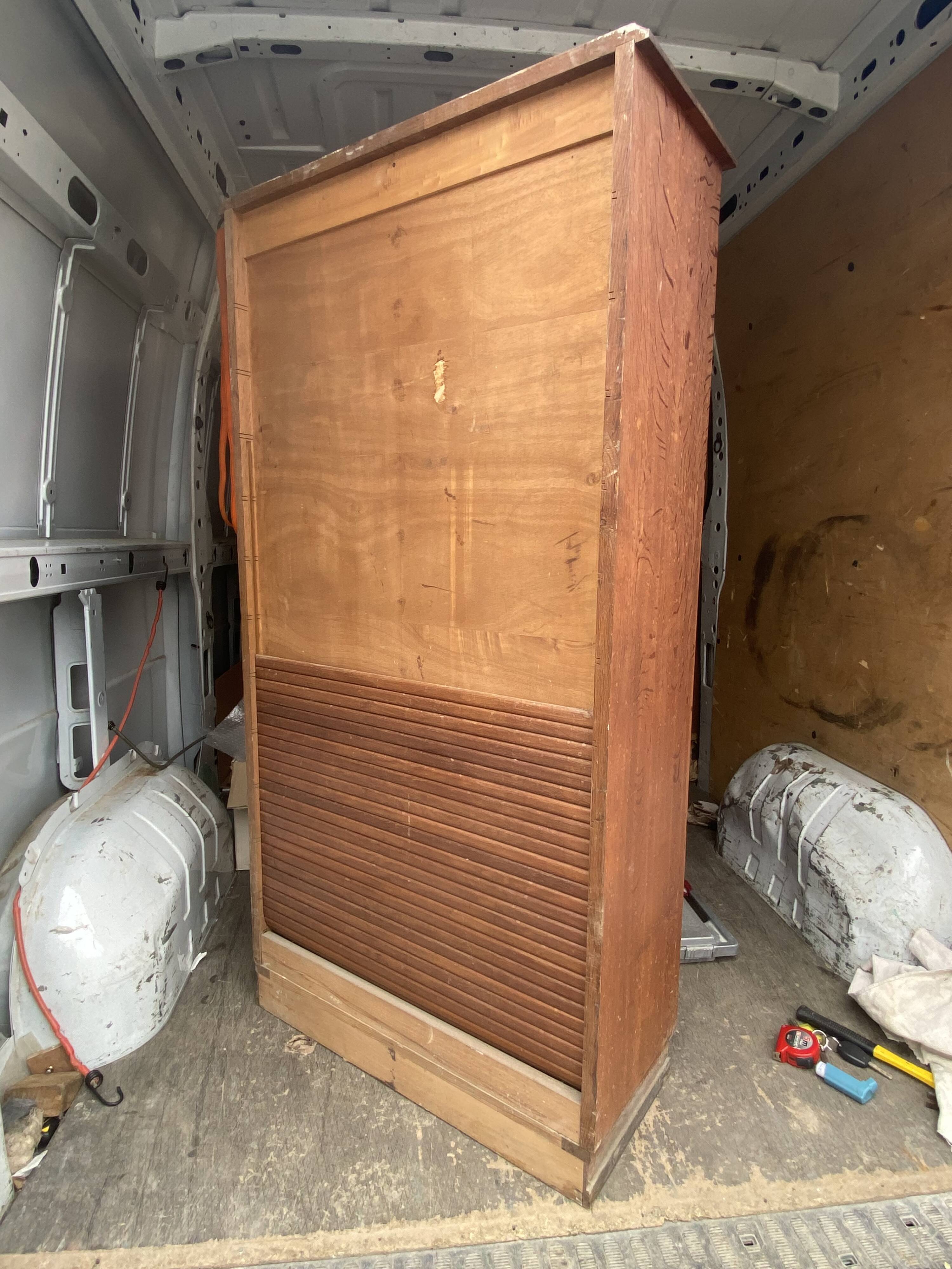Oak two-column filing cabinet with curtains.