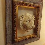 Antique gilded frame with stone lion head ornament on plexiglass