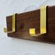 Vintage wooden and brass coat rack with 3 hooks from the 1960s.