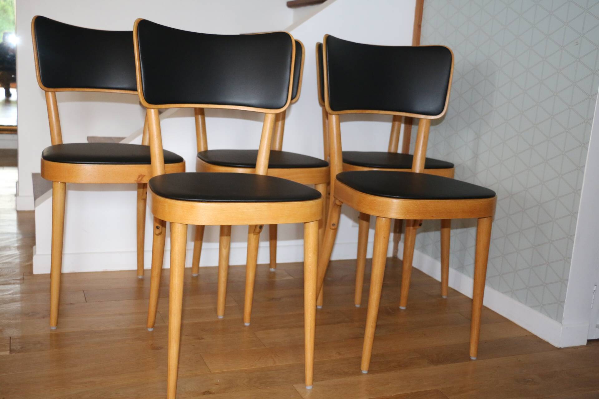 5 baumann chairs with large backs in black faux leather.