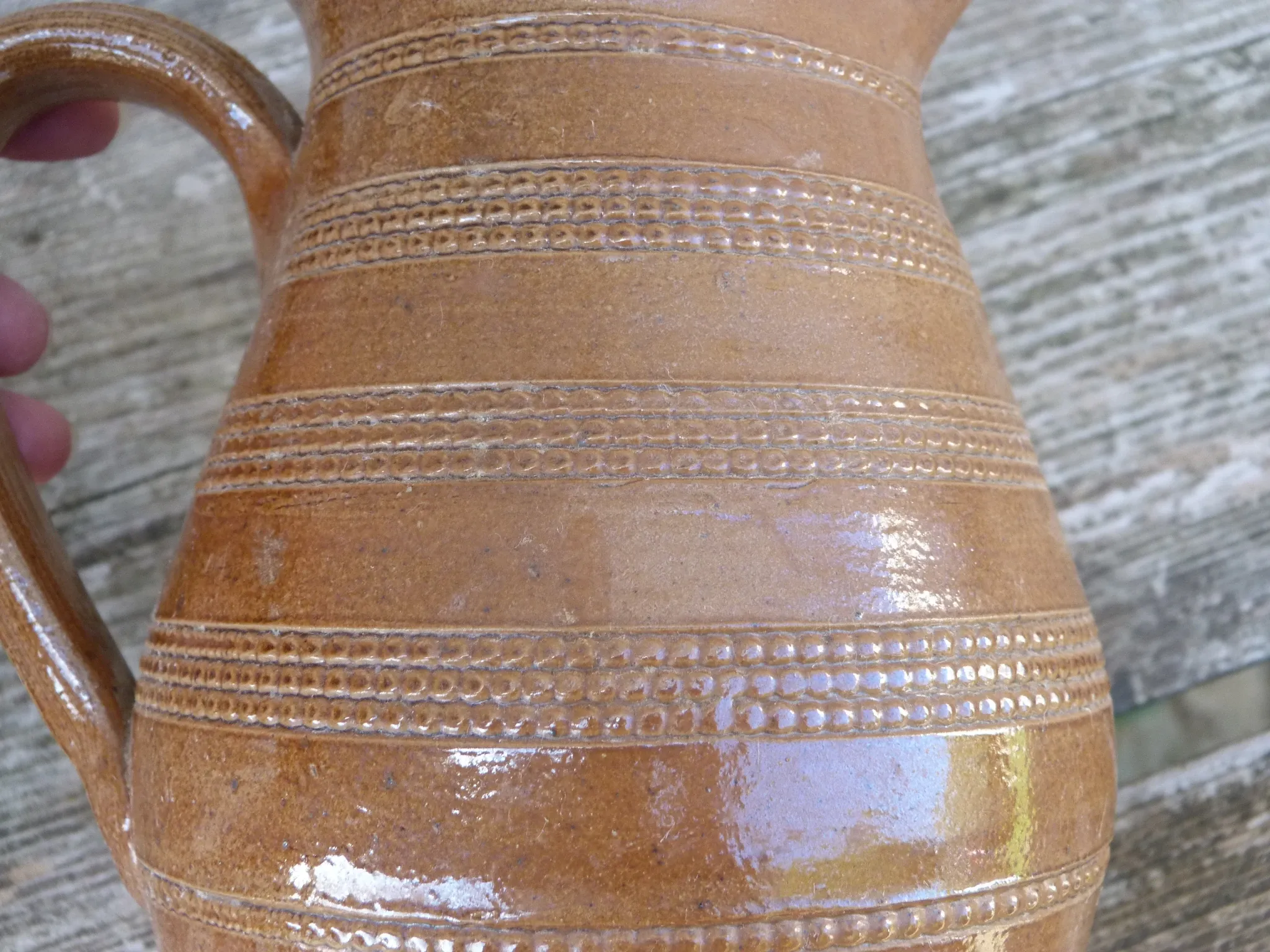 Old stoneware wine jug with patterns