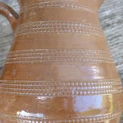 Old stoneware wine jug with patterns