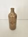 Pyrite stoneware single-flower vase in the shape of a bottle signed Aular?
