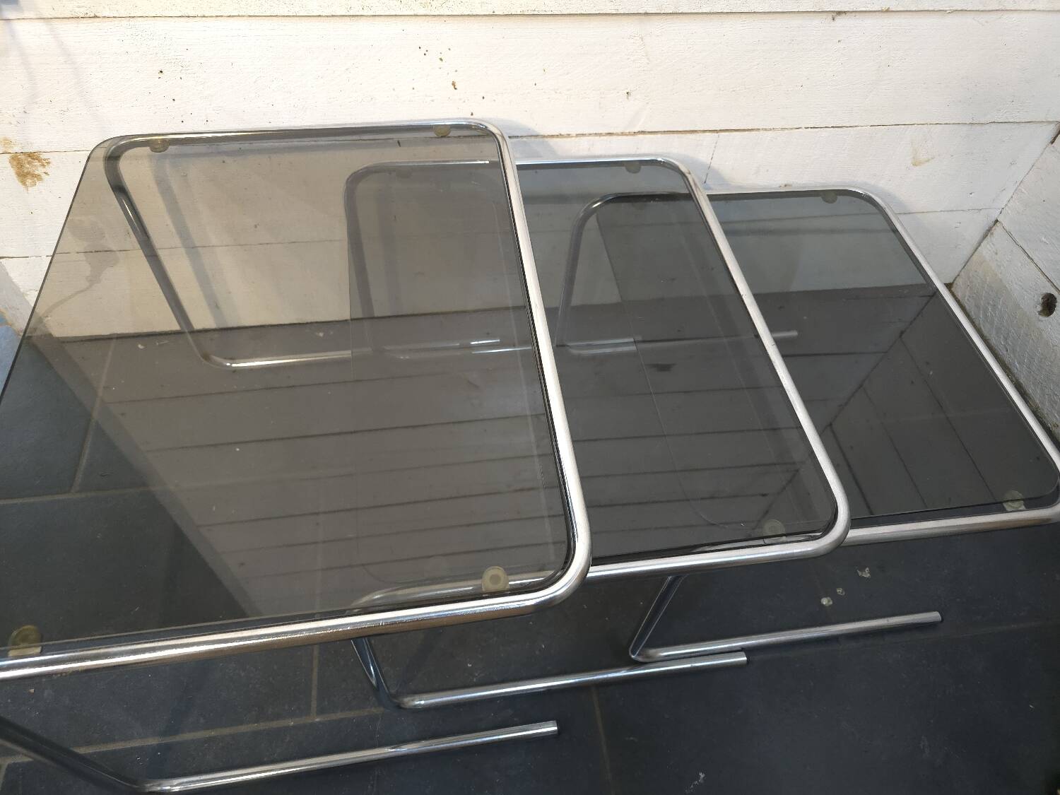 Nesting tables in chromed metal with smoked glass tops from the 1970s
