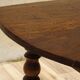 Walnut drop-leaf table with honey spoon legs.