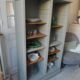 Vintage furniture transformed into a bookcase, verdigris patinated sideboard.