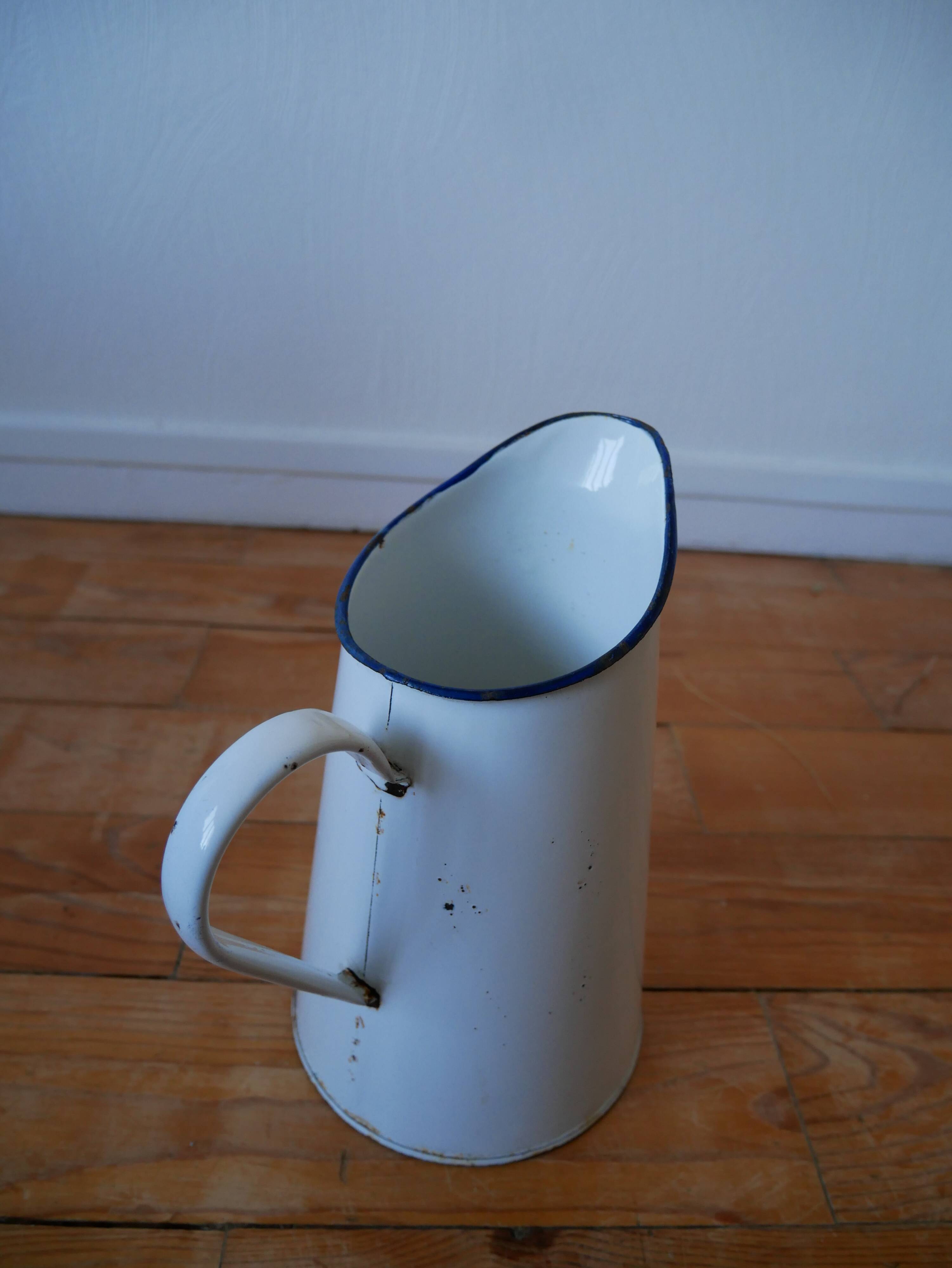 White enamelled metal broc