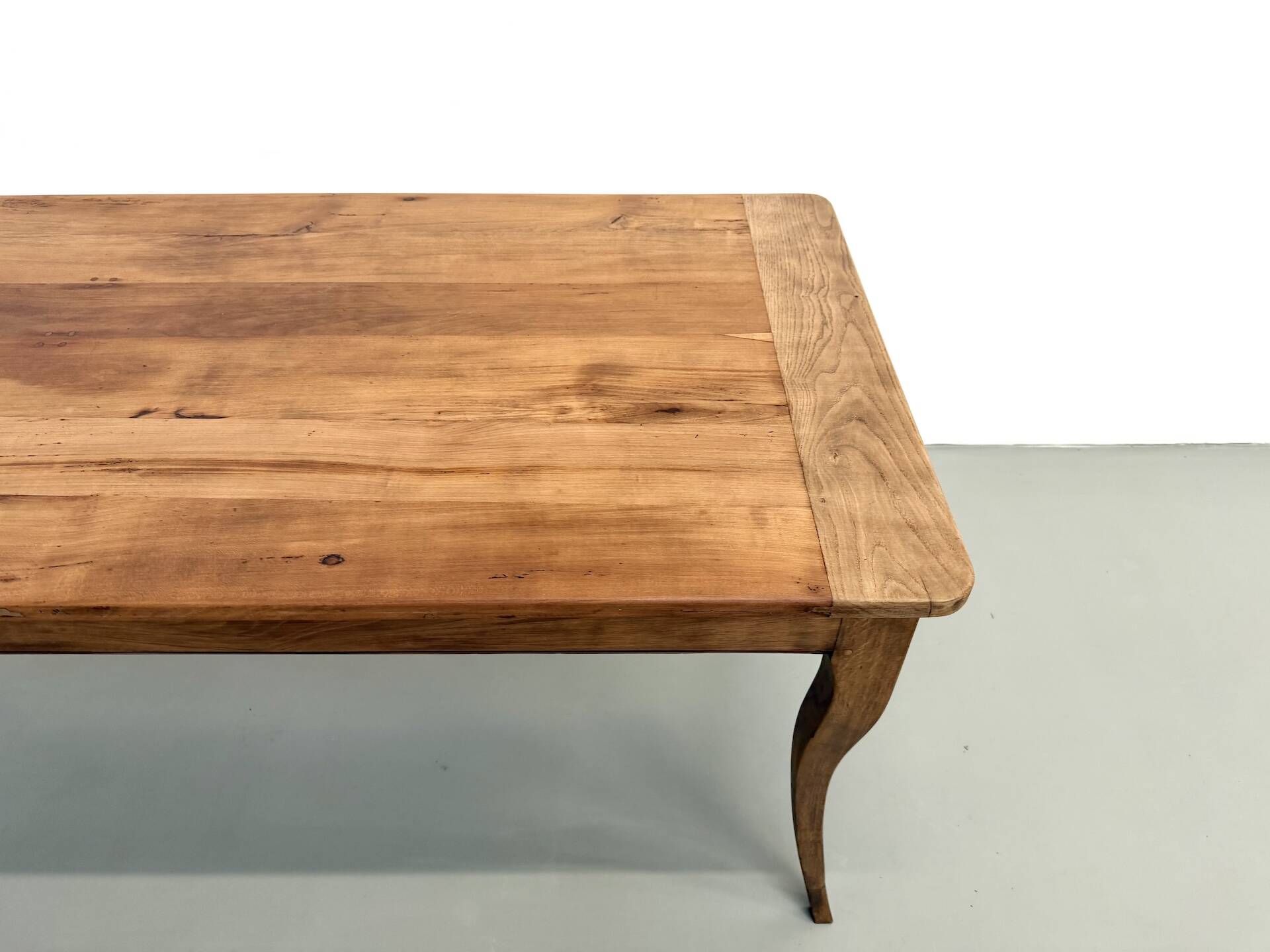 Farm table in solid cherry — Saber legs, Circa 1880