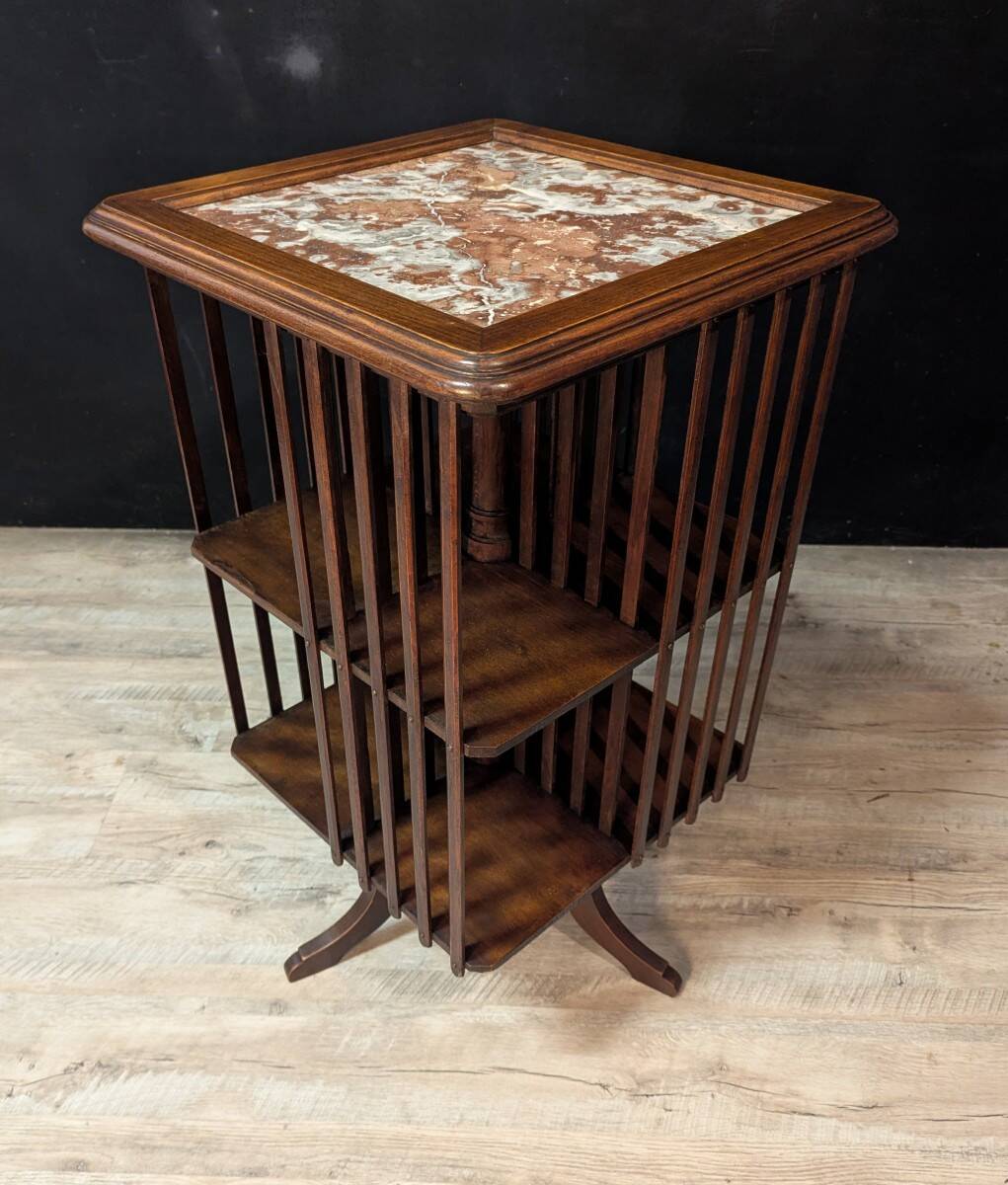 Rotating walnut library with a marble top.