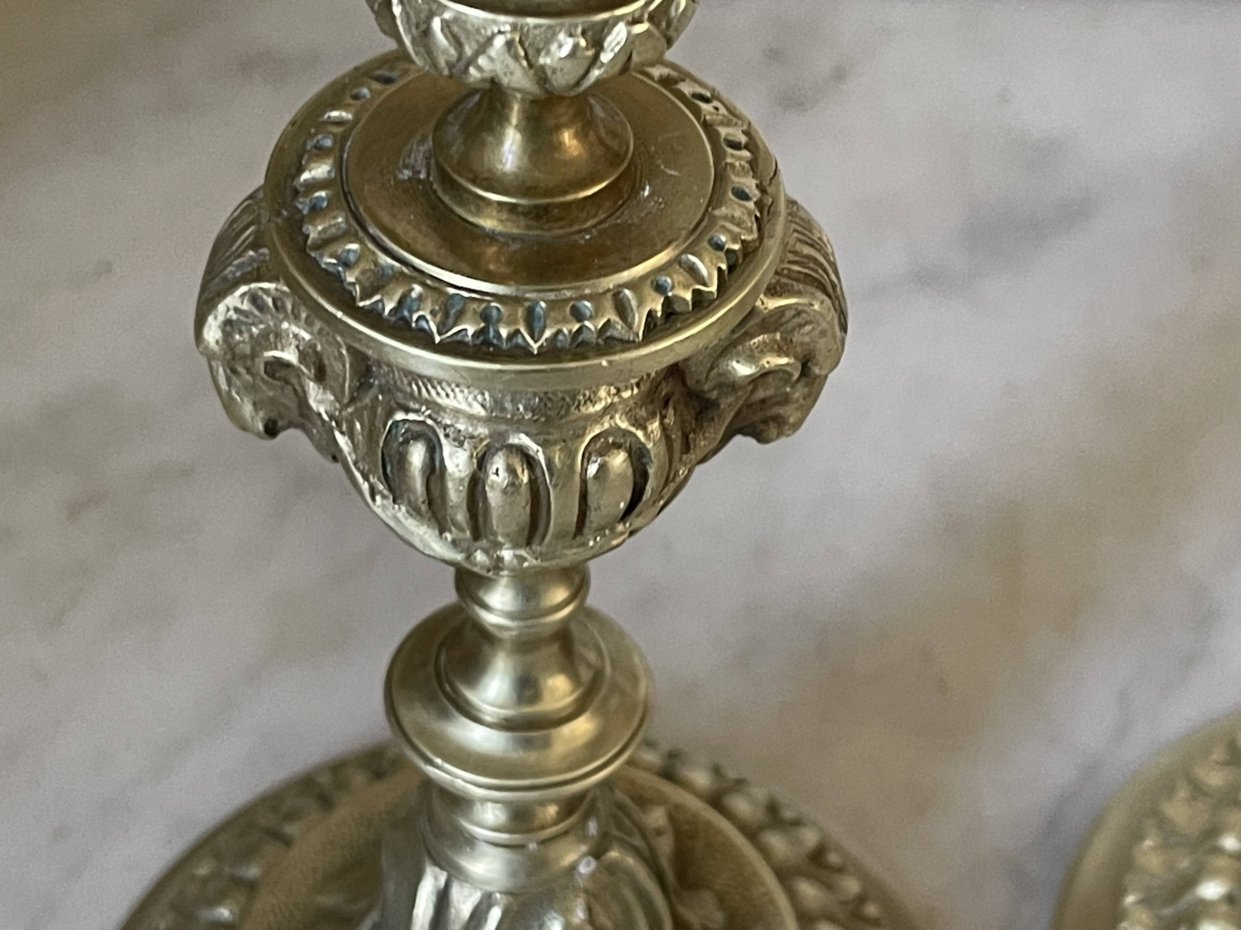 Pair of gilt bronze ram's head candlesticks, Louis XVI style, 19th century.