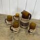 Carafe and glasses in amber glass and rattan