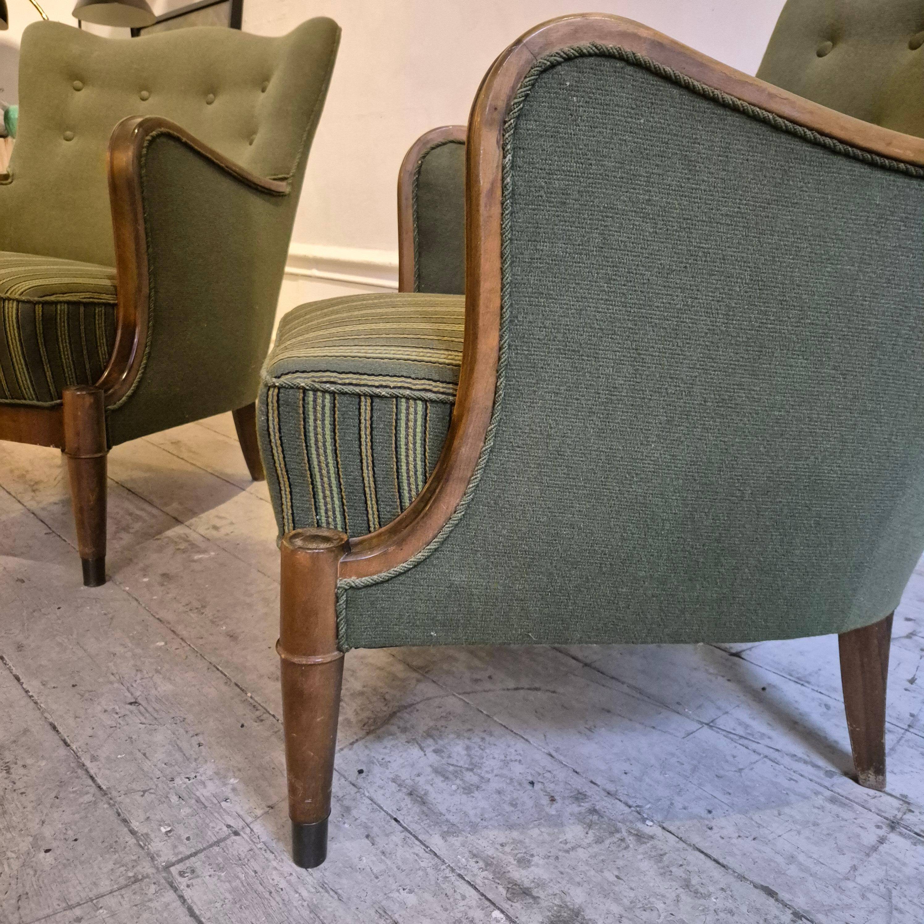 Modern Danish armchairs by Alfred Christensen. Beautiful shape, brass legs.